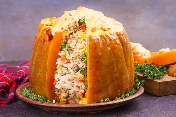 Stuffed pumpkin with meat, rice, mushrooms,  pepper and thyme. Baked butternut squash with rice