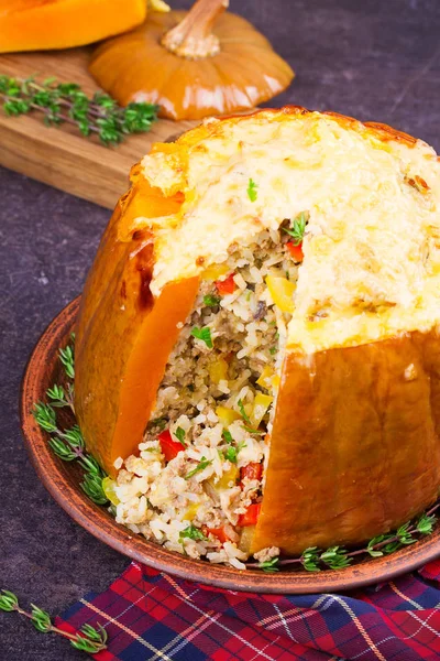 Stuffed pumpkin with meat, rice, mushrooms,  pepper and thyme. Baked butternut squash with rice