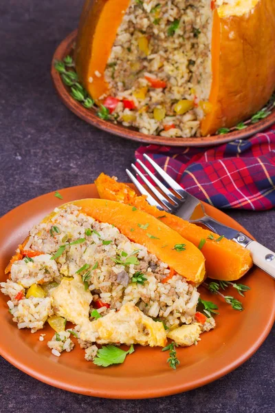 Stuffed pumpkin with meat, rice, mushrooms,  pepper and thyme. Baked butternut squash with rice