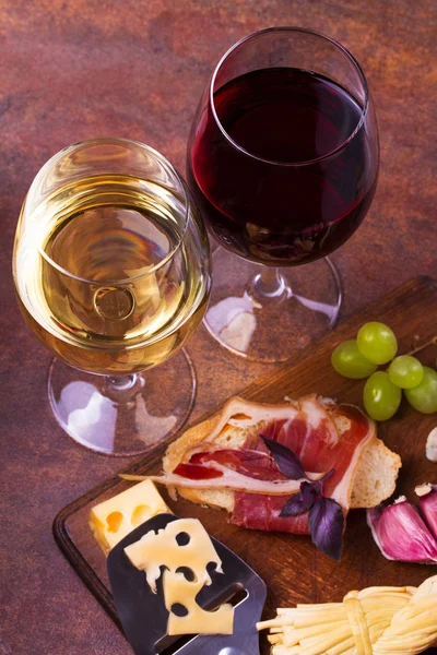 Glasses of red and white wine with cheese
