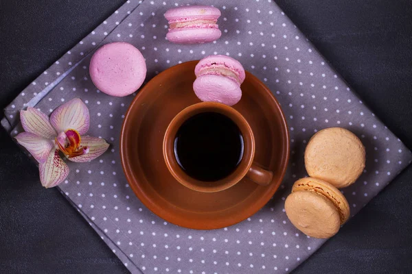 Coffee and cake macaron or macaroon on gray background from above