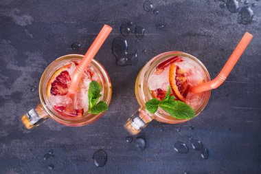 Kanlı turuncu kokteyl kavanozlara nane ile süslenmiş
