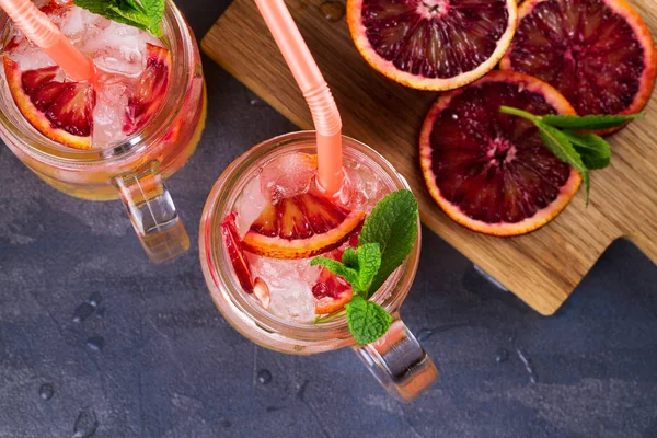 Bloody orange cocktail garnished with mint in the jars — Stock Photo, Image