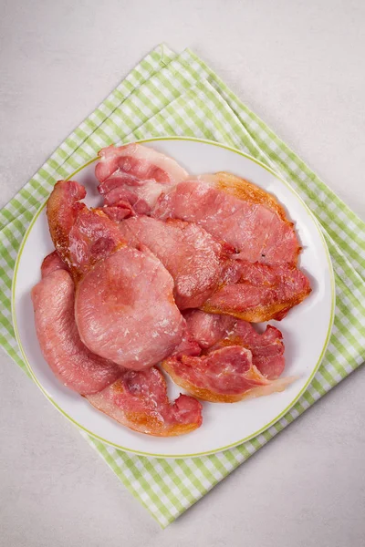 Bacon on white plate. Grilled rashers — Stock Photo, Image