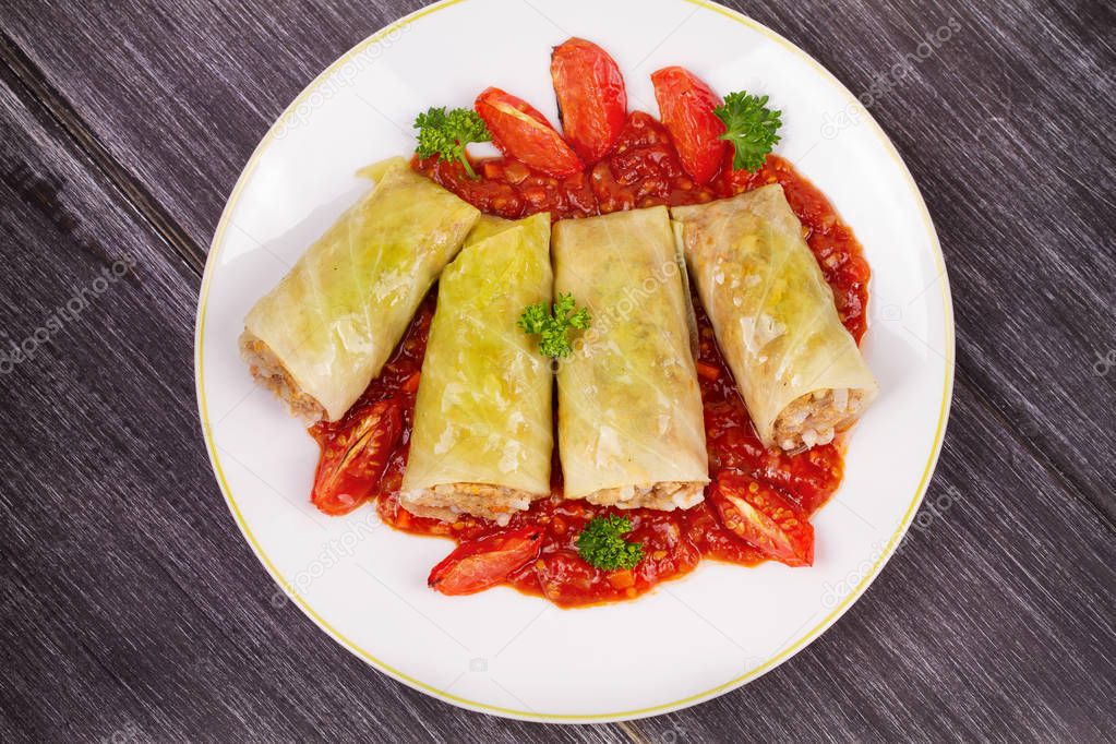 Cabbage rolls with meat, rice and vegetables in tomato sauce. Stuffed cabbage leaves with meat. Dolma, sarma, sarmale, golubtsy or golabki - traditional and popular dish in many countries