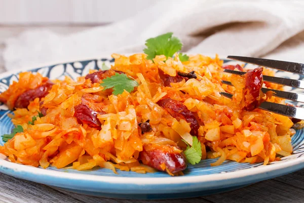 Cabbage with sausages, carrot, onion and tomato sauce — Stock Photo, Image