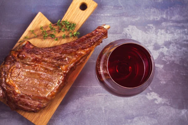 Glass of red wine and rib eye beef steak