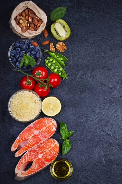 Detox healthy food concept with salmon fish, vegetables, fruits and ingredients for cooking. Selection of healthy and good for heart food