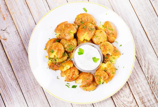 Smashed Potatoes with parsley, dried rosemary, lemon zest and yogurt sauce — Stock Photo, Image