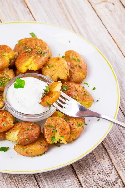 Smashed Potatoes with parsley, dried rosemary, lemon zest and yogurt sauce — Stock Photo, Image