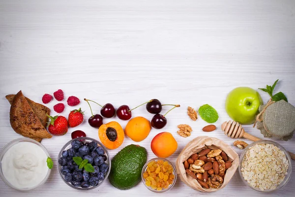 Yoghurt, Haver vlokken, fruit, honing en zomer bessen. Weergave van bovenaf, top studio shot van groenten achtergrond — Stockfoto