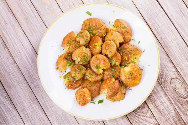 Smashed Potatoes with parsley and rosemary — Stock Photo, Image