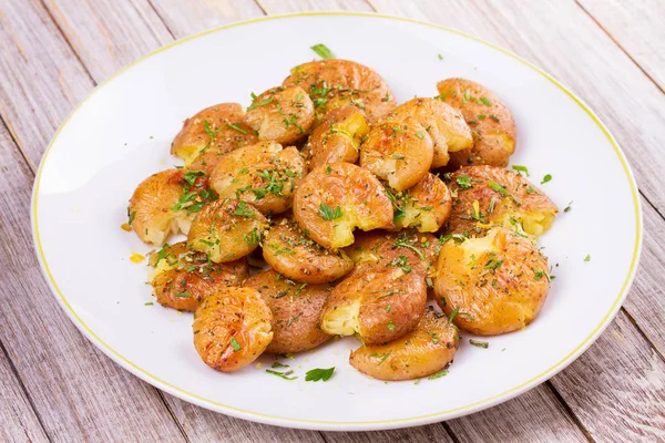 Smashed Potatoes with parsley and rosemary — Stock Photo, Image