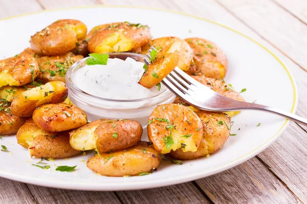 Smashed Potatoes with parsley and rosemary — Stock Photo, Image