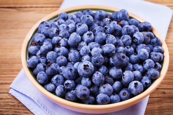 Yaban mersini kil kase. Taze çilek rustik arka plan üzerinde aldı