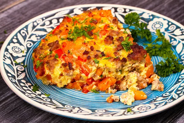 Frittata - dish made with fried beaten eggs, pumpkin (or butternut squash), sausage and red pepper