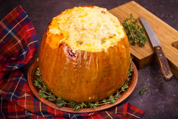 Stuffed pumpkin with rice, mushrooms, meat, eggs and vegetables, garnished with thyme — Stock Photo, Image