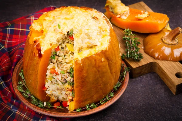 Stuffed pumpkin with rice, mushrooms, meat, eggs and vegetables, garnished with thyme — Stock Photo, Image