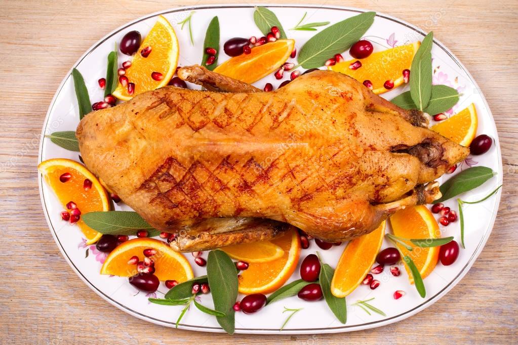 Whole duck with oranges, berries, sage and rosemary