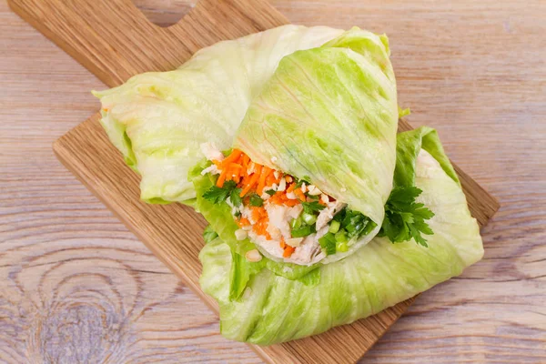 Lettuce wraps with chicken, carrot, peanuts and ginger-scallion oil,