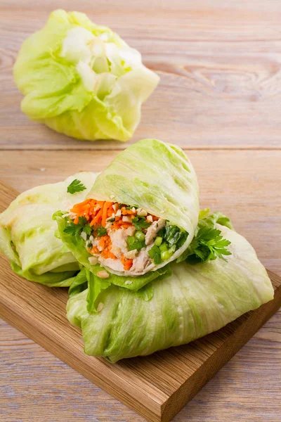 Lettuce wraps with chicken, carrot, peanuts and ginger-scallion oil,