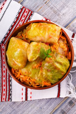 Etli lahana dolması bırakır. Lahana et, pilav ve sebze ile alır. Dolma, sarma, sarmale, golubtsy veya golabki