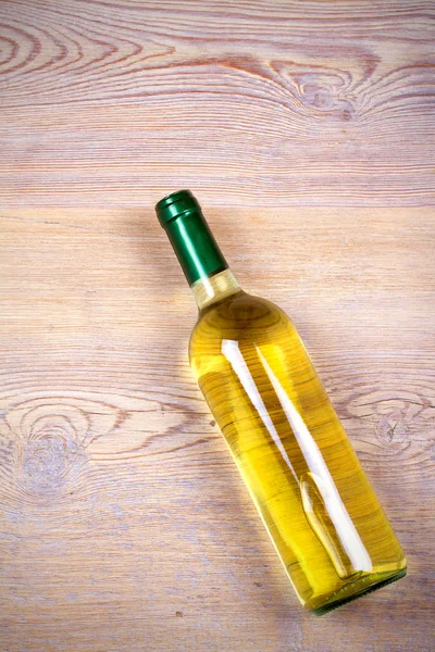 Bottle of wine on rustic wooden background. — Stock Photo, Image