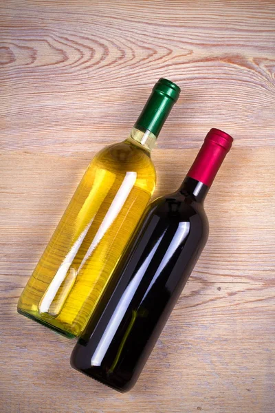 Bottle of wine on rustic wooden background. — Stock Photo, Image