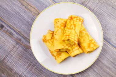 Mantar beyaz plaka üzerinde kaydırılan ince krep dolu