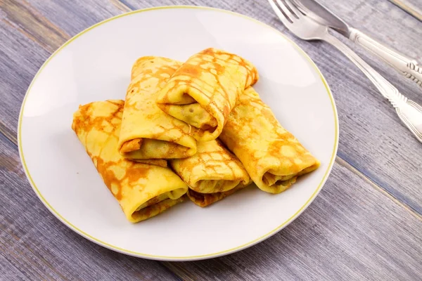 Wrapped thin pancakes  filled with mushrooms on white plate — Stock Photo, Image