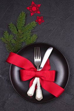 Tabak, çatal bıçak takımı, kırmızı kurdele ve çilek ile Noel tablo ayarı. Kış tatili ve festival arka plan. Noel arifesi Akşam Yemeği, yılbaşı yiyecek öğle yemeği. Yukarıdan görüntülemek, top, dikey
