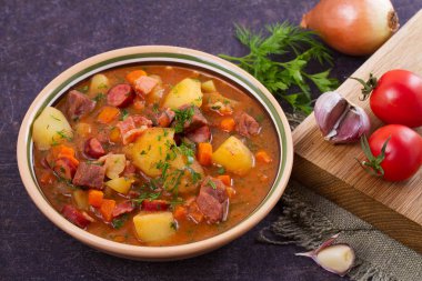 Güveç, sığır eti, pastırma, sosis patates, havuç ve otlar ile yapılan. Gulaş çorbası bograch bir kabın içinde. Macar çanak