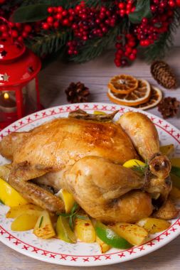 Bütün kızarmış tavuk ya da hindi patates, limon ve limes Noel ve yeni yıl arka planda, dikey