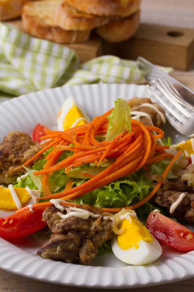 Chicken liver, carrot, eggs, tomatoes, lettuce and fried onion salad. Liver and vegetables