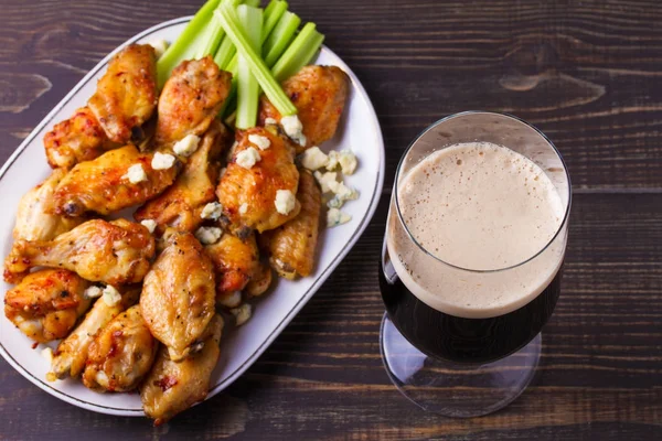 Beer and chicken wings buffalo with blue cheese and celery sticks. View from above, top, horizontal