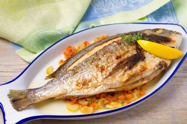 Bütün kılıçbalığı veya dorada balık sebze, kekik ve limon, yatay