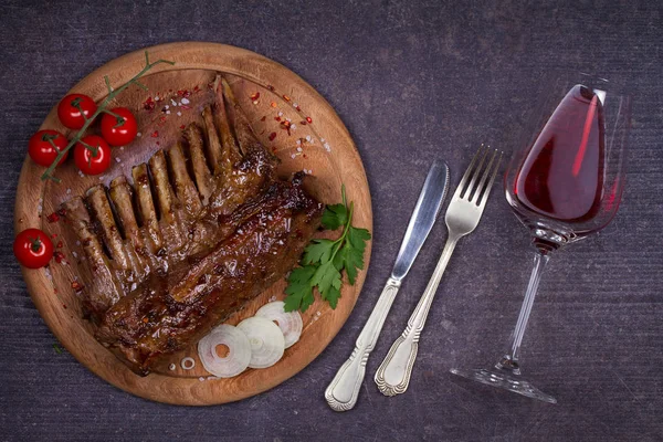 Glass and bottle of red wine with lamb chops. Wine and meat. Wine and food conception. View from above, top, horizontal