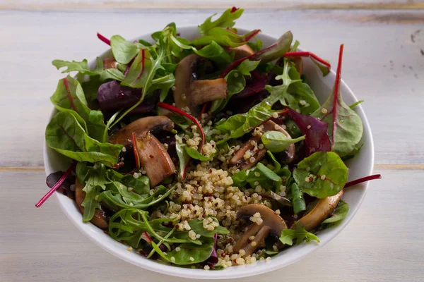 Quinoa salad with mushrooms, herbs, spinach, arugula. Quinoa healthy superfood concept. Clean healthy detox eating. Vegan and vegetarian food.