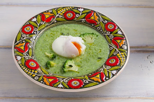 Broccoli spinach soup and poached egg. Vegetable vegetarian soup, healthy food. Creamy soup. horizontal
