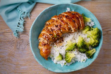 Glased chicken breast, rice and broccoli as garnish. Chicken in balsamic vinegar and brown sugar sauce clipart