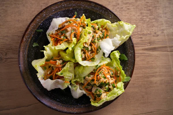 Stuffed iceberg lettuce cabbage leaves with chicken and vegetables. Wraps pockets of lettuce with chicken. overhead