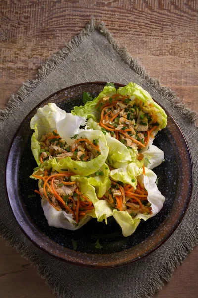 Stuffed iceberg lettuce cabbage leaves with chicken and vegetables. Wraps pockets of lettuce with chicken. overhead