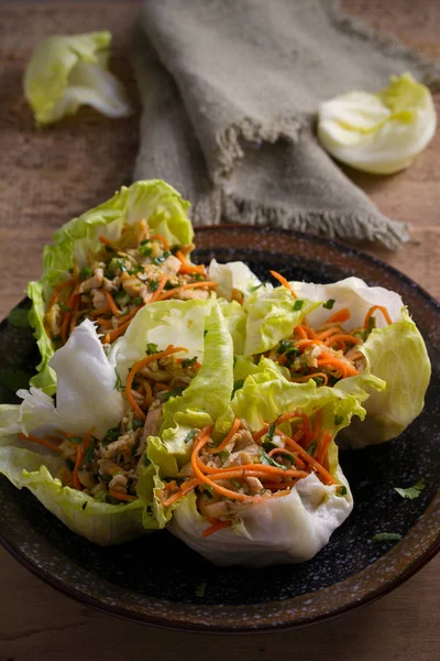 Stuffed iceberg lettuce cabbage leaves with chicken and vegetables. Wraps pockets of lettuce with chicken