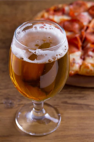 Beer and pizza. Glass of beer. Ale and appetizer snack.