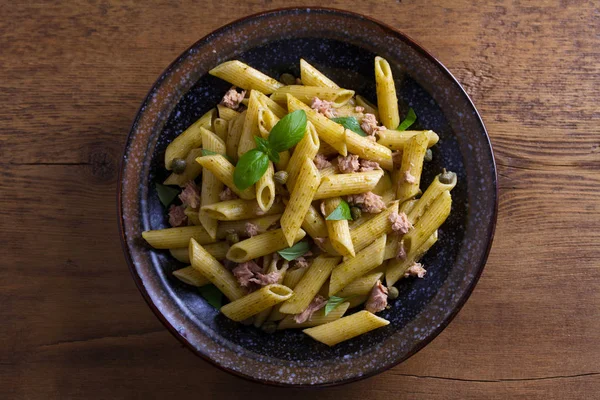 Tuna, basil and caper penne. Pasta with tuna fish. View from above, top studio shot