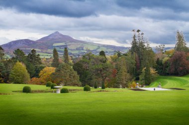 Enniskerry, County Wicklow, Ireland - October 28, 2019: Powerscourt House and Gardens is one of Ireland top tourist attraction. View to Sugar Loaf Mountain clipart