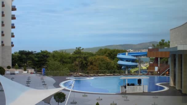 empty pool water park without visitors in the courtyard of the resort on a background of mountains
