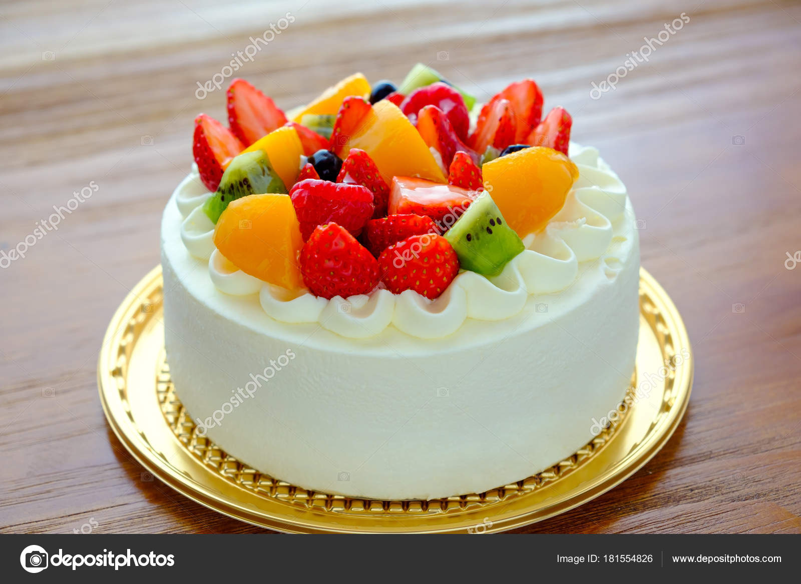 Cake With Exotic Fruits Over Wooden Background Stock Photo
