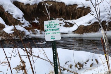 New Haven, WI / USA  - January 12 / 2020: Easement sign to notify public fishing is allowed clipart