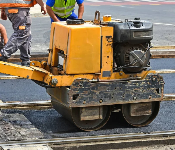 Road construction with steam roller